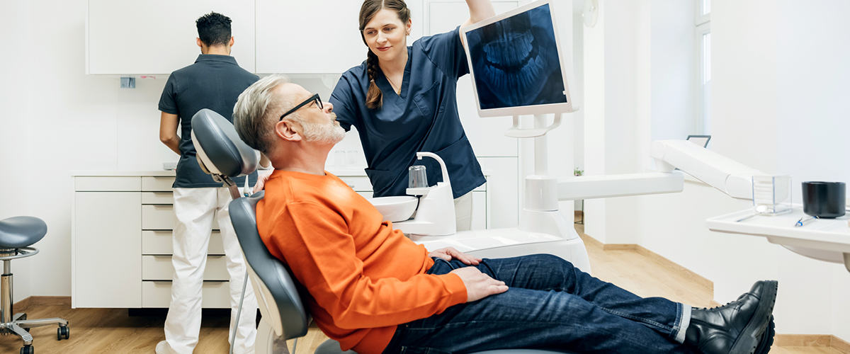 A patient reviewing x-rays in a dental office.