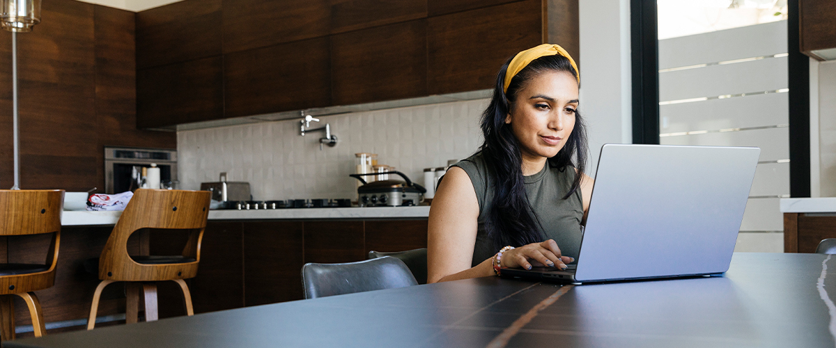 Woman using a comupter at home.
