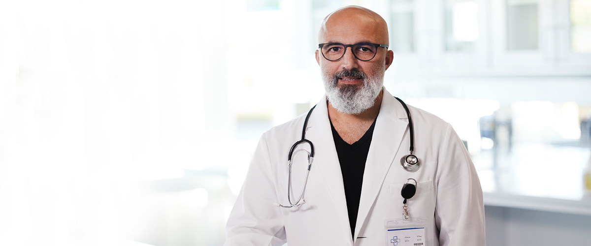 Doctor posing in his office,