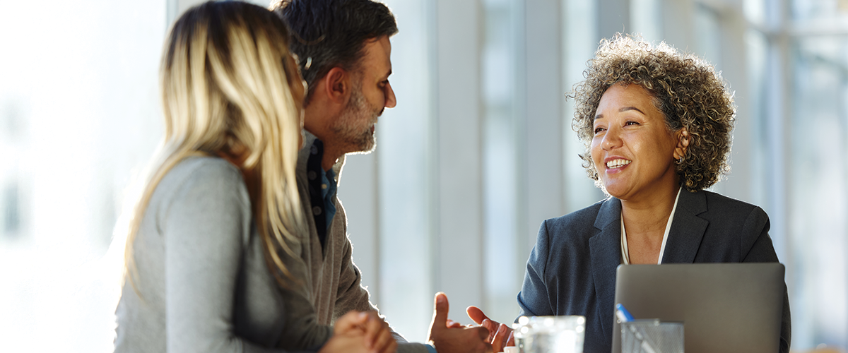 A group of colleagues meeting in an office setting.
